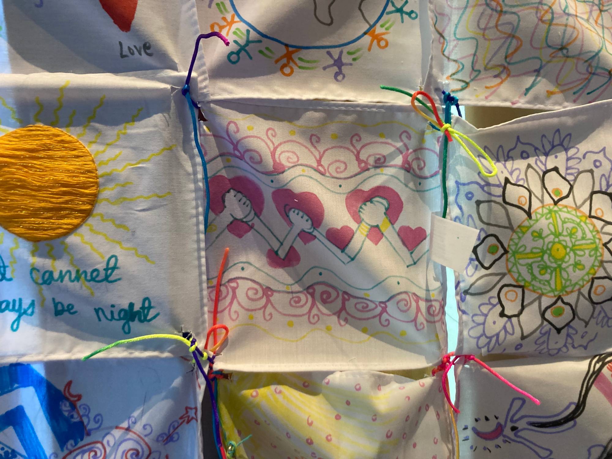 A closeup of a tapestry created as part of the Interfaith America Summit 2024